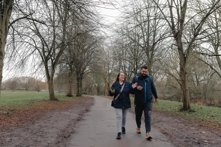 Chelmsford couple having a walking coffee chat in park