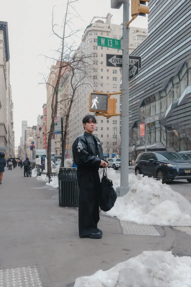 Man waiting at stop sign in Manhattan