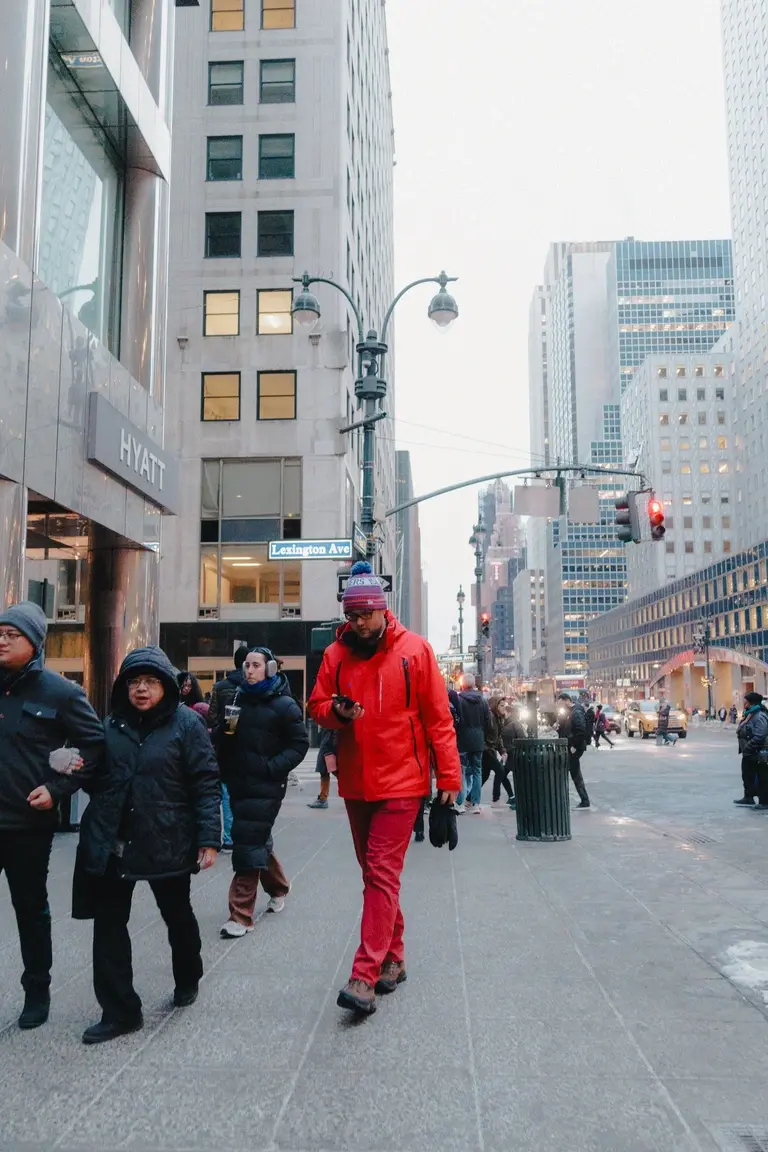 Man in red walking down New York street