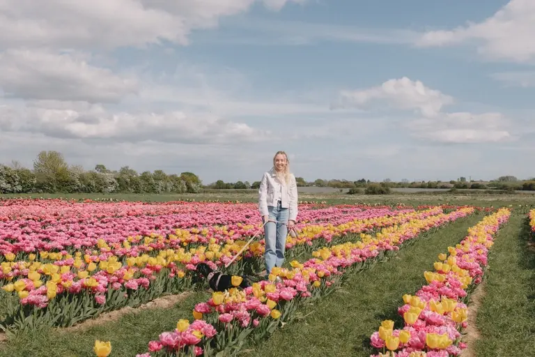 Abbie standing in the tulip fields with Olive at Scott's of Southend
