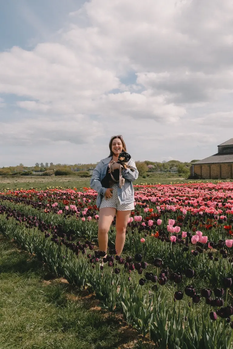 Bekah holding Olive in the tulip fields at Scott's of Southend