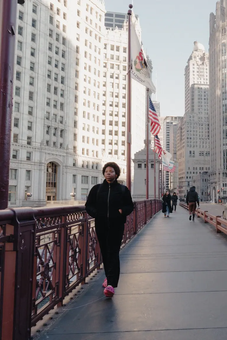 Lady walking down Wabash Avenue Bridge