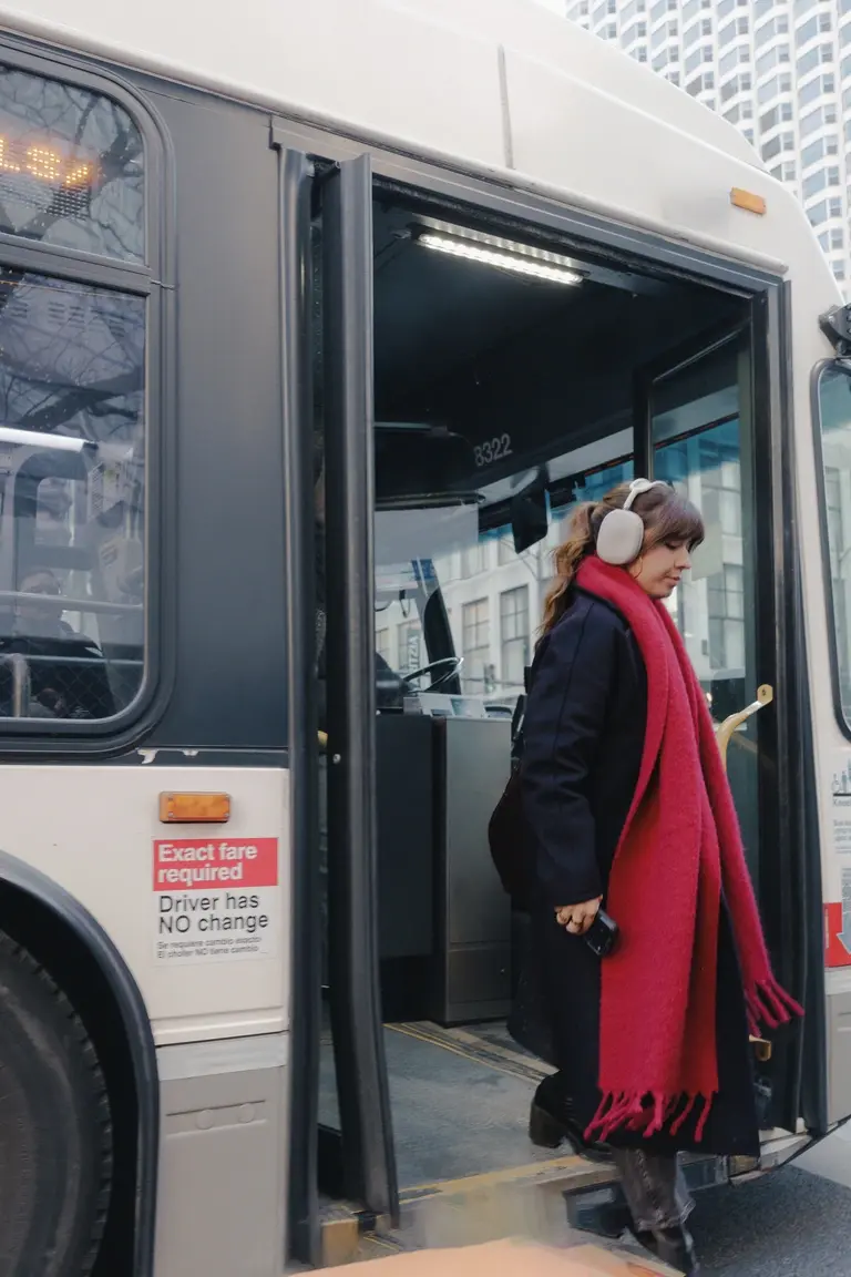 Woman stepping off bus in Chicago