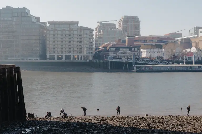 People on edge of river thames