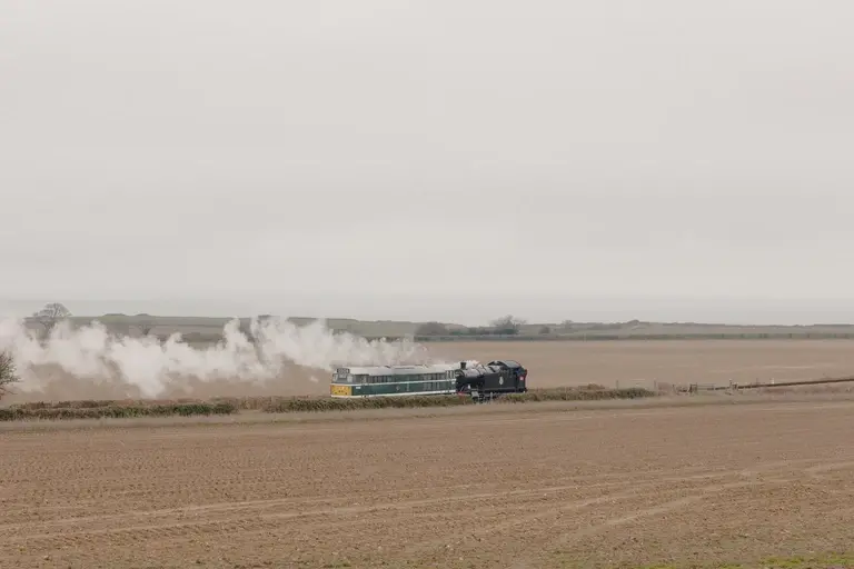 Steam train pulling single carriage