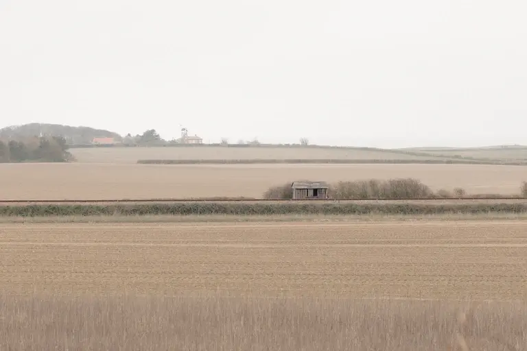 Old train line hut among winter fields