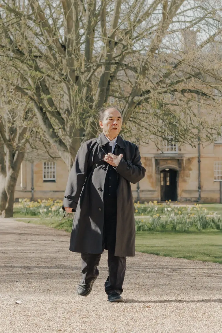 Man walking through Downing College