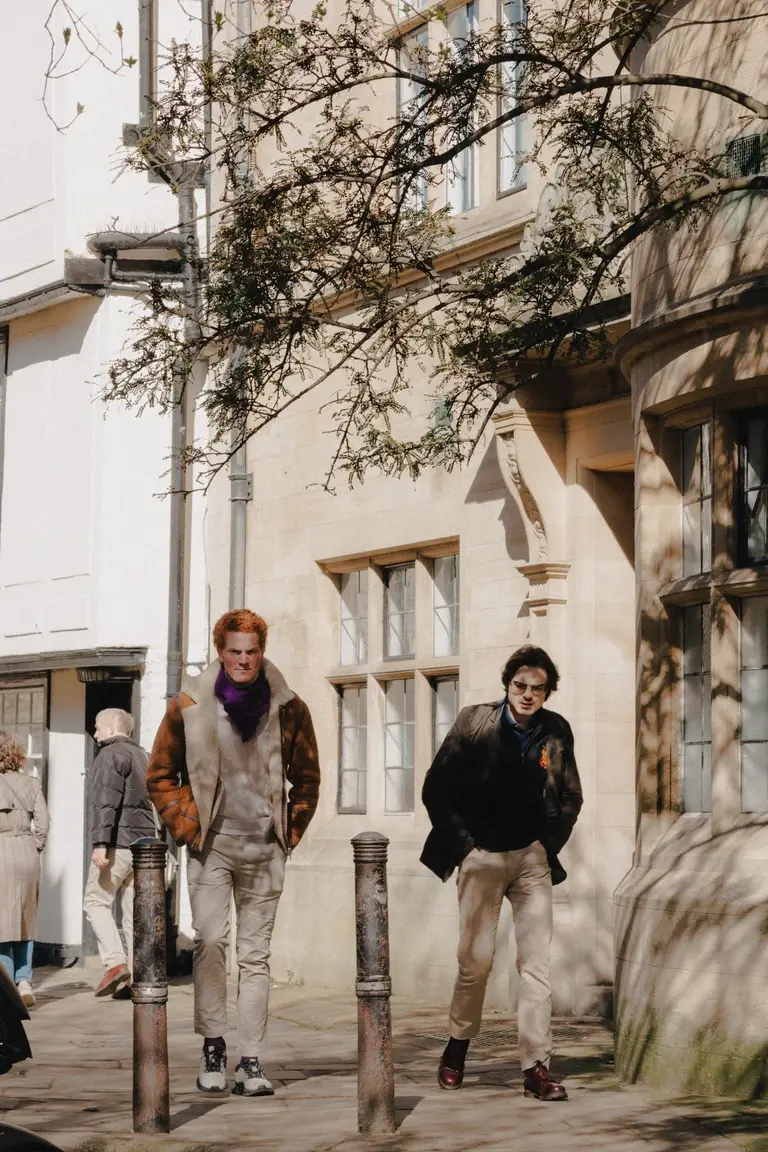 Men walking up quiet cambridge city lane