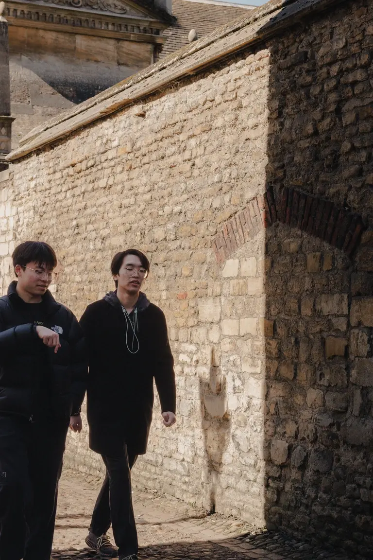 Men walking down quiet and old Cambridge lane