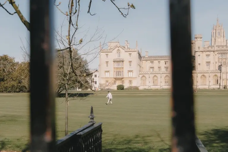 Jewish man walking across the green at St. John's College, Cambridge