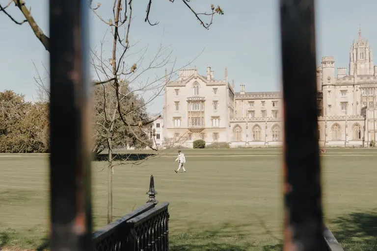 Jewish man walking across the green at St. John's College, Cambridge