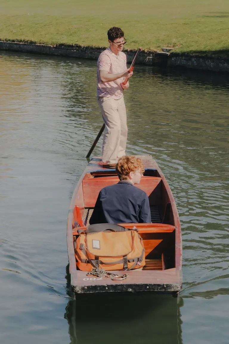 Man punting young boy down River Cam