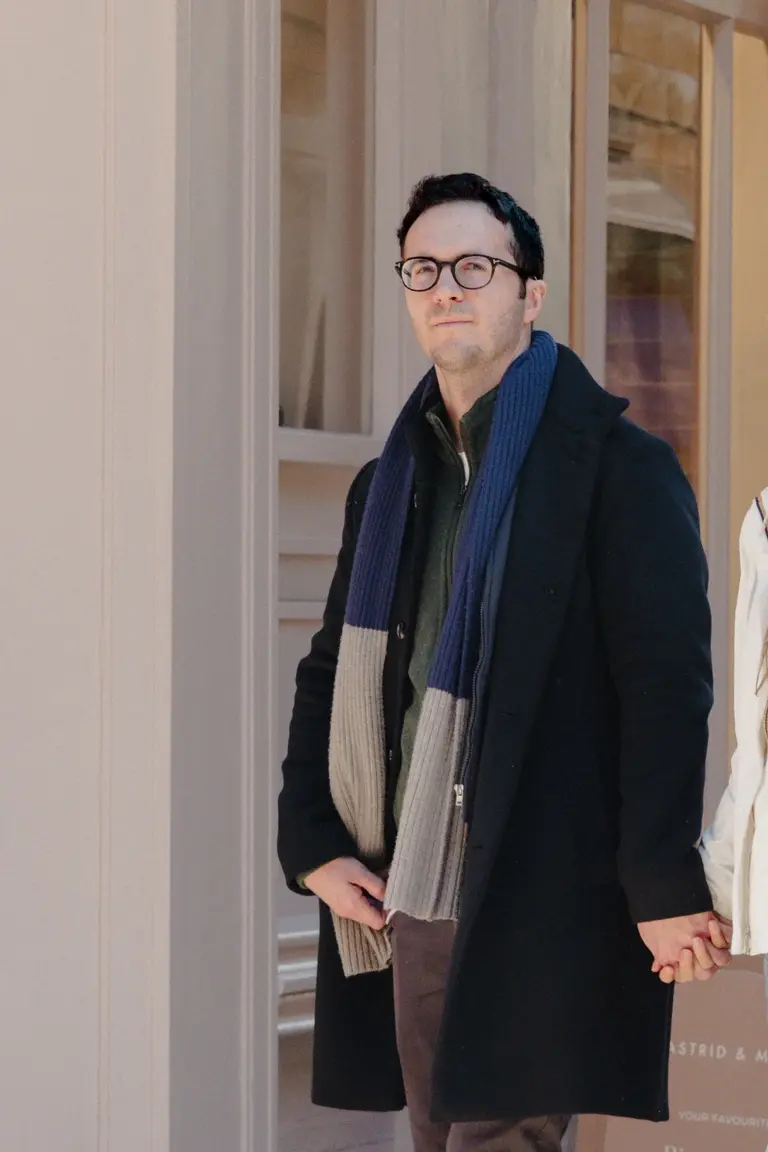 Man walking down cambridge lane holding partners hand