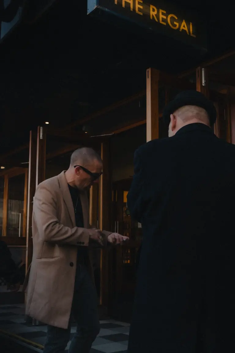 Men having a discussion outside The Regal, Cambridge