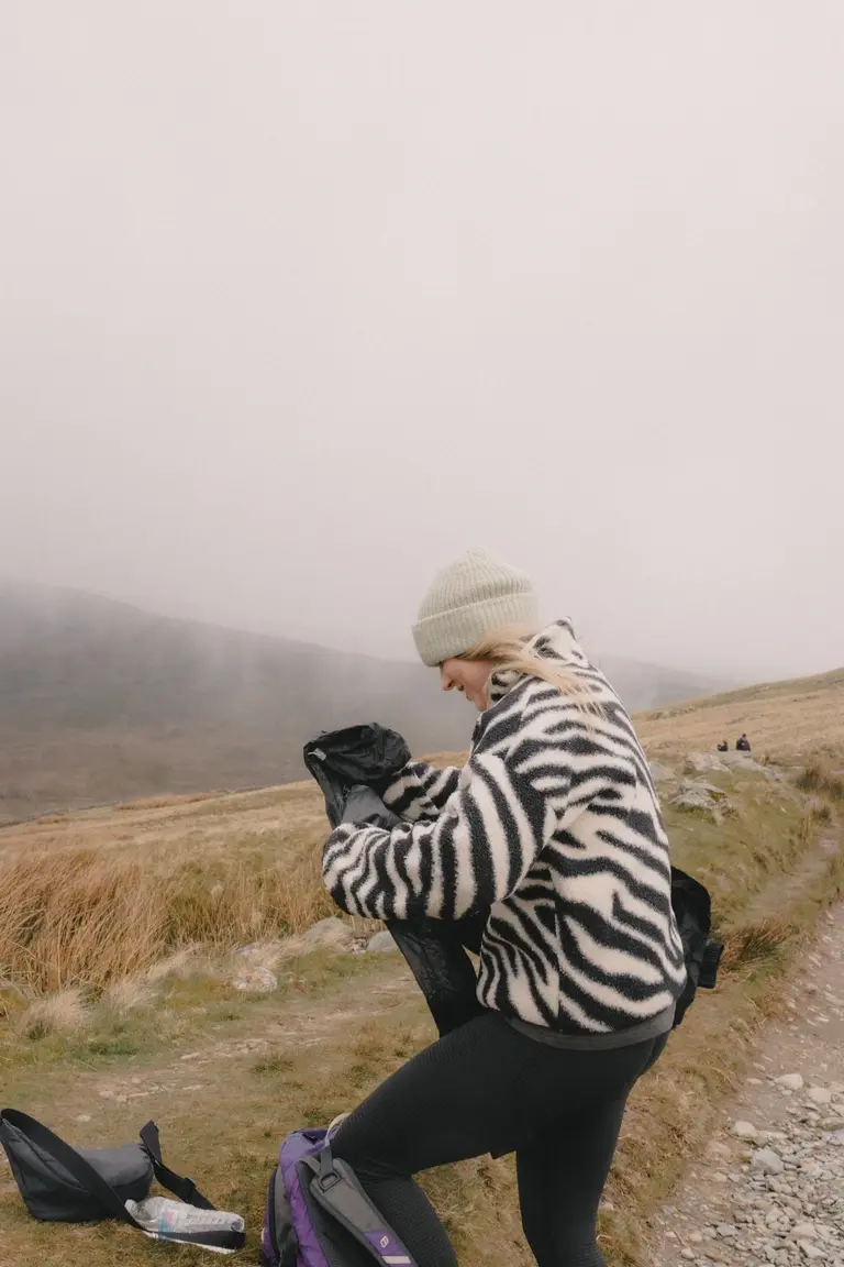 Unpacking waterproofs on Snowdon climb