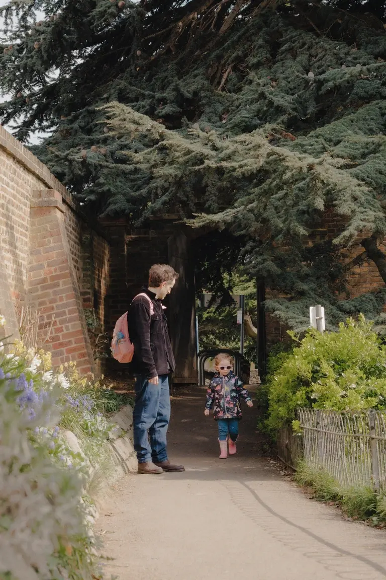 Father and daughter walking into Leigh-on-Sea park