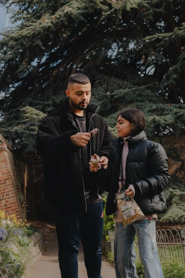 Father and daughter sharing ice cream
