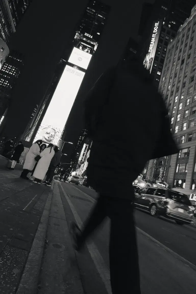Man briskly walking past Times Square