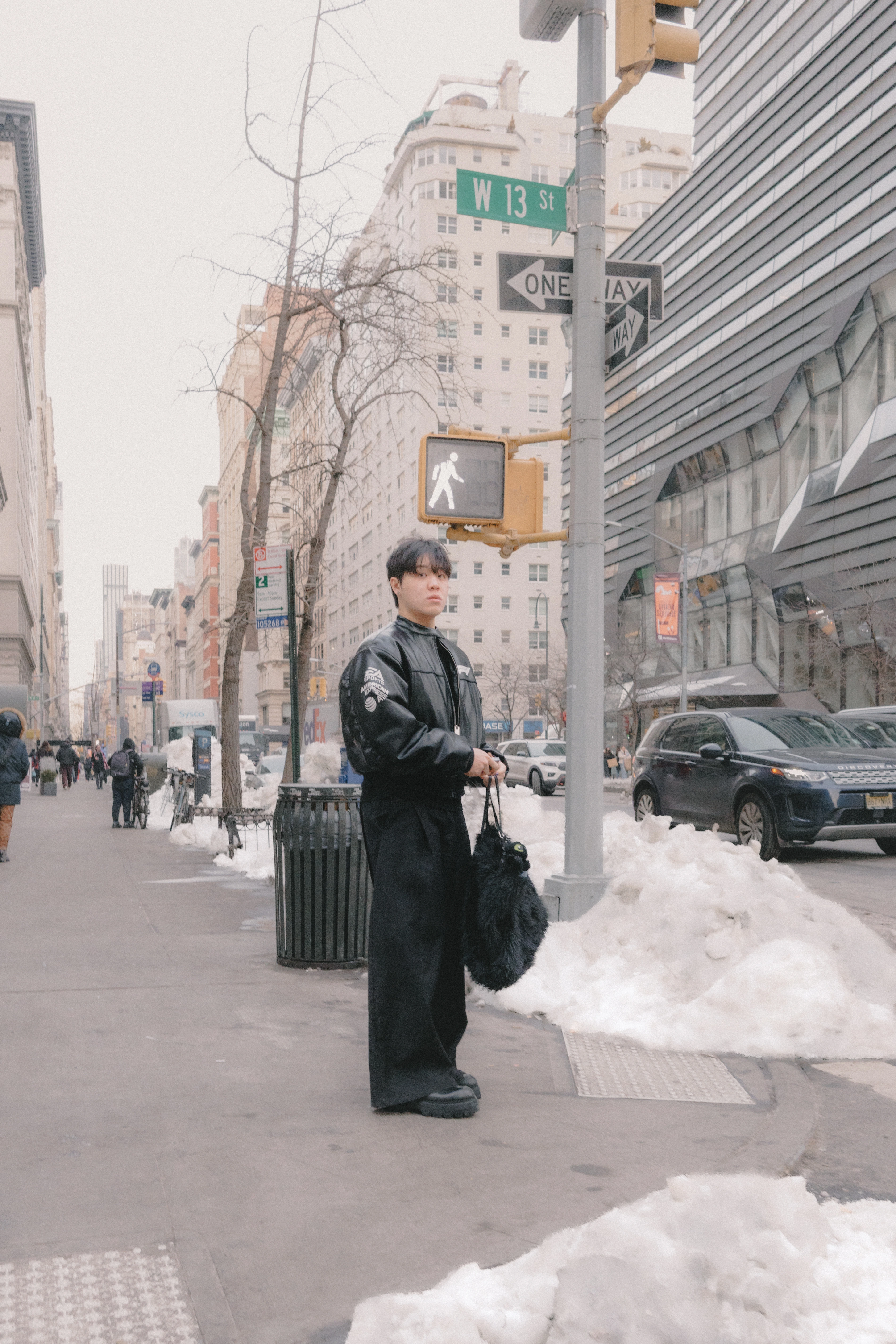 Man waiting at stop sign in Manhattan