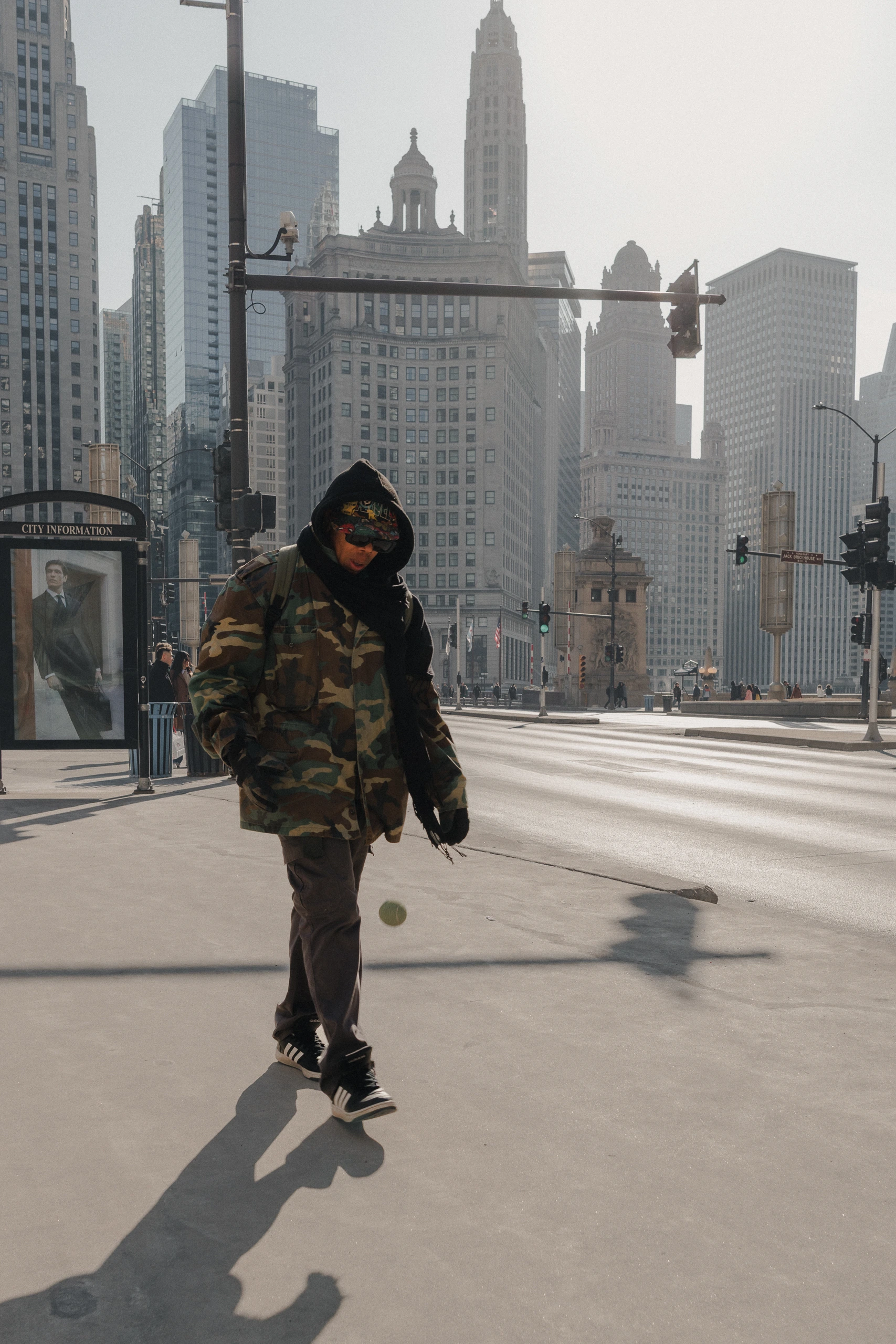 Man bouncing ball strolling in downtown Chicago