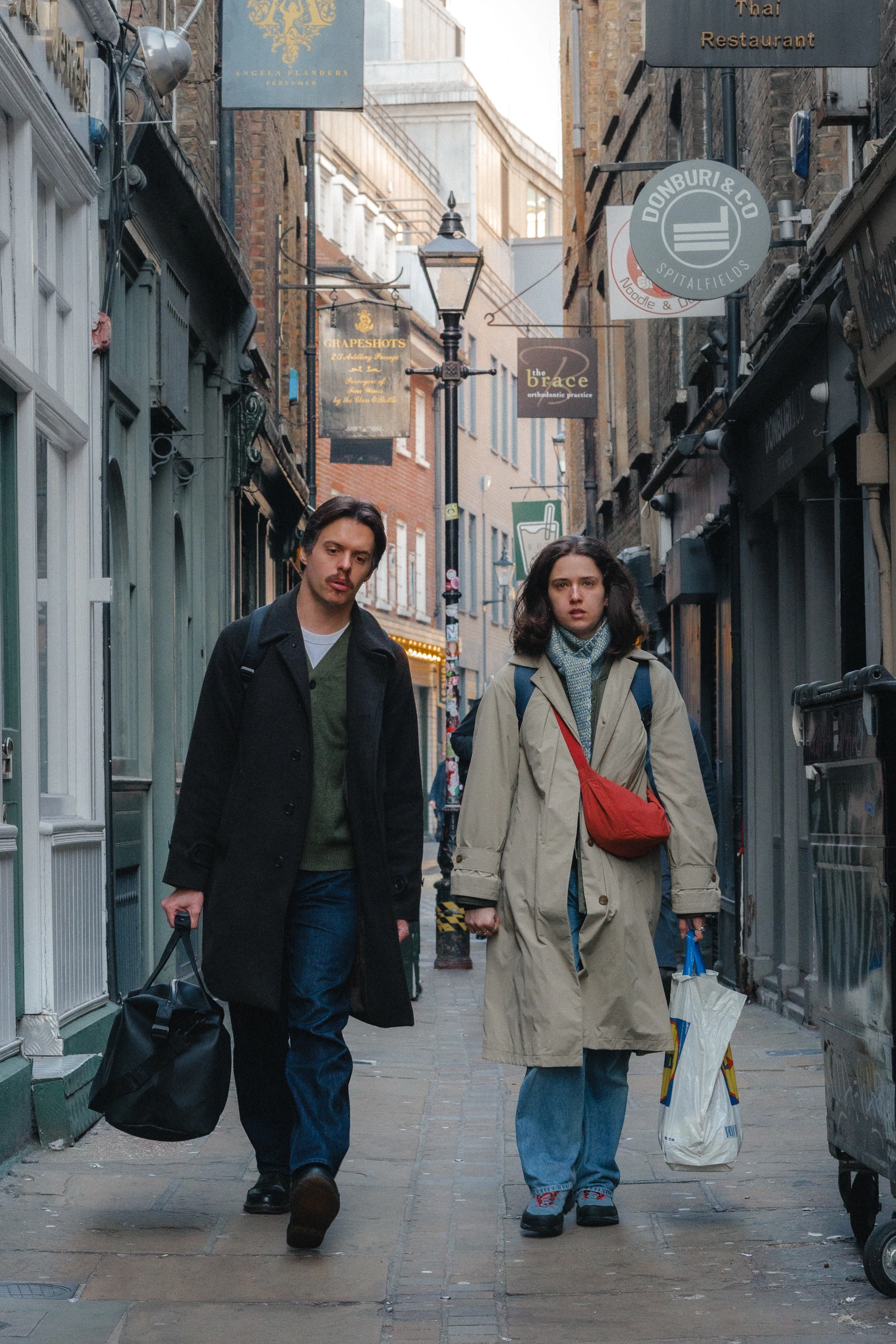 Couple wandering through Spitalfield's alleys