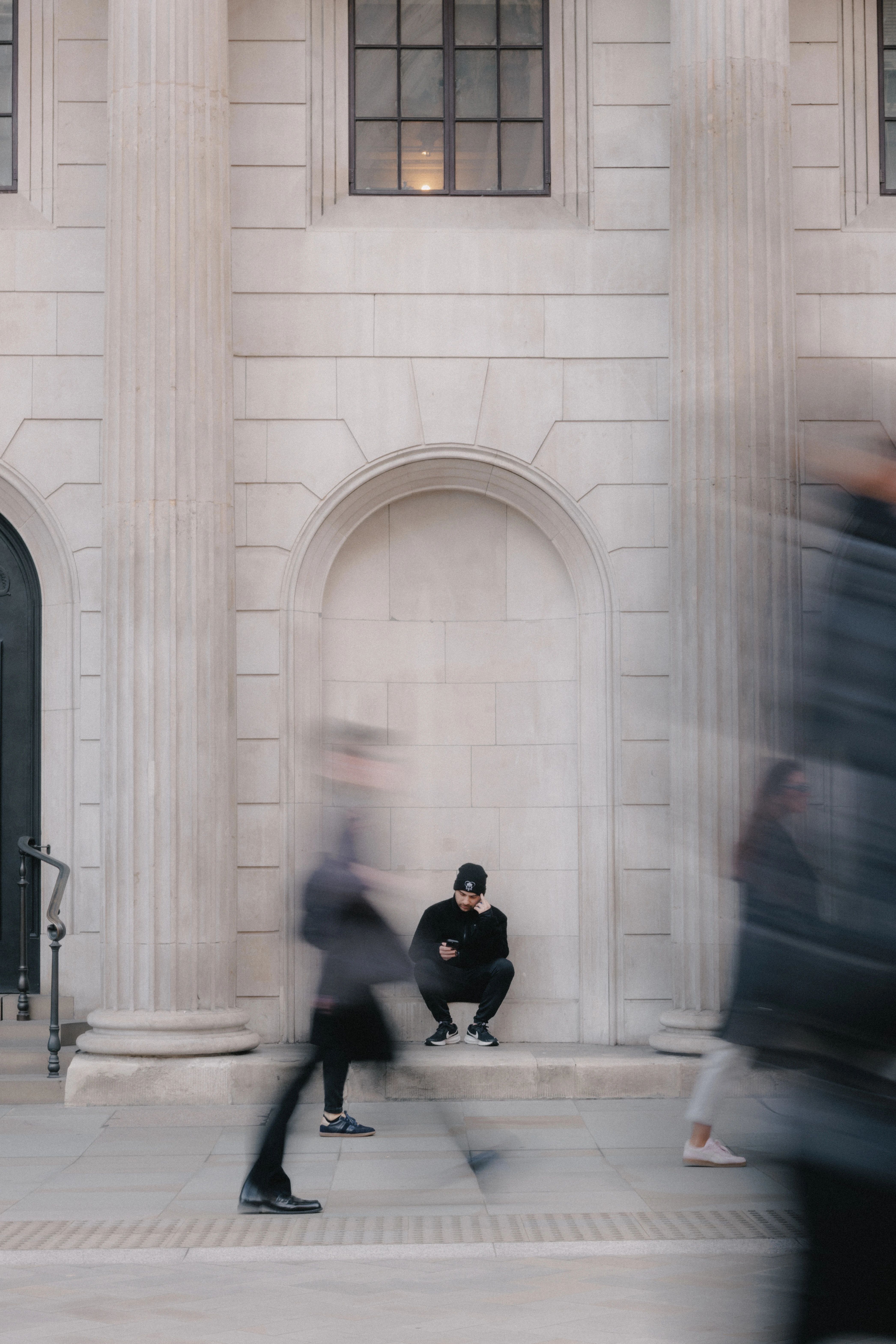 Man sitting down outside The Royal Exchange