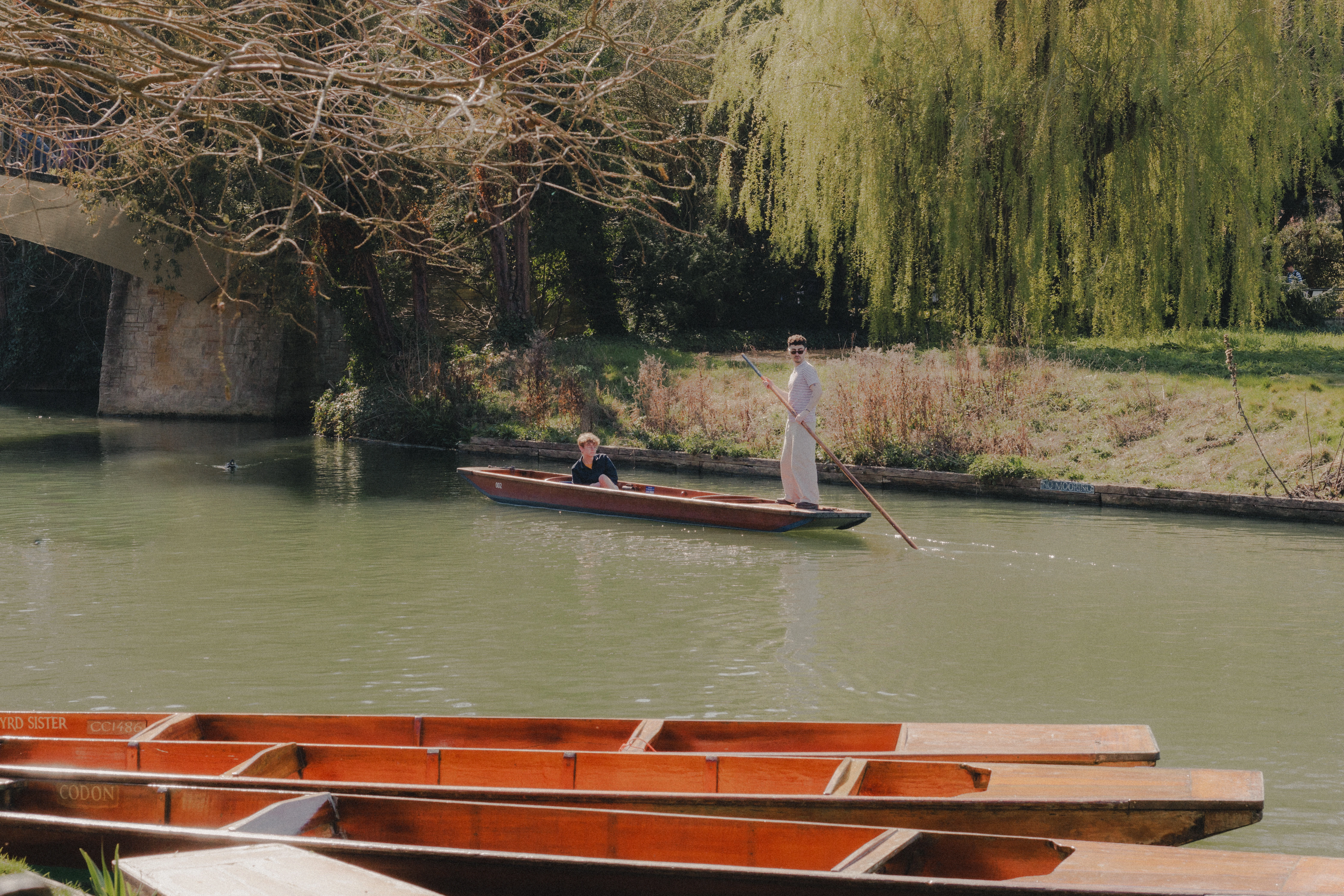 Punting down River Cam with boats in the foreground