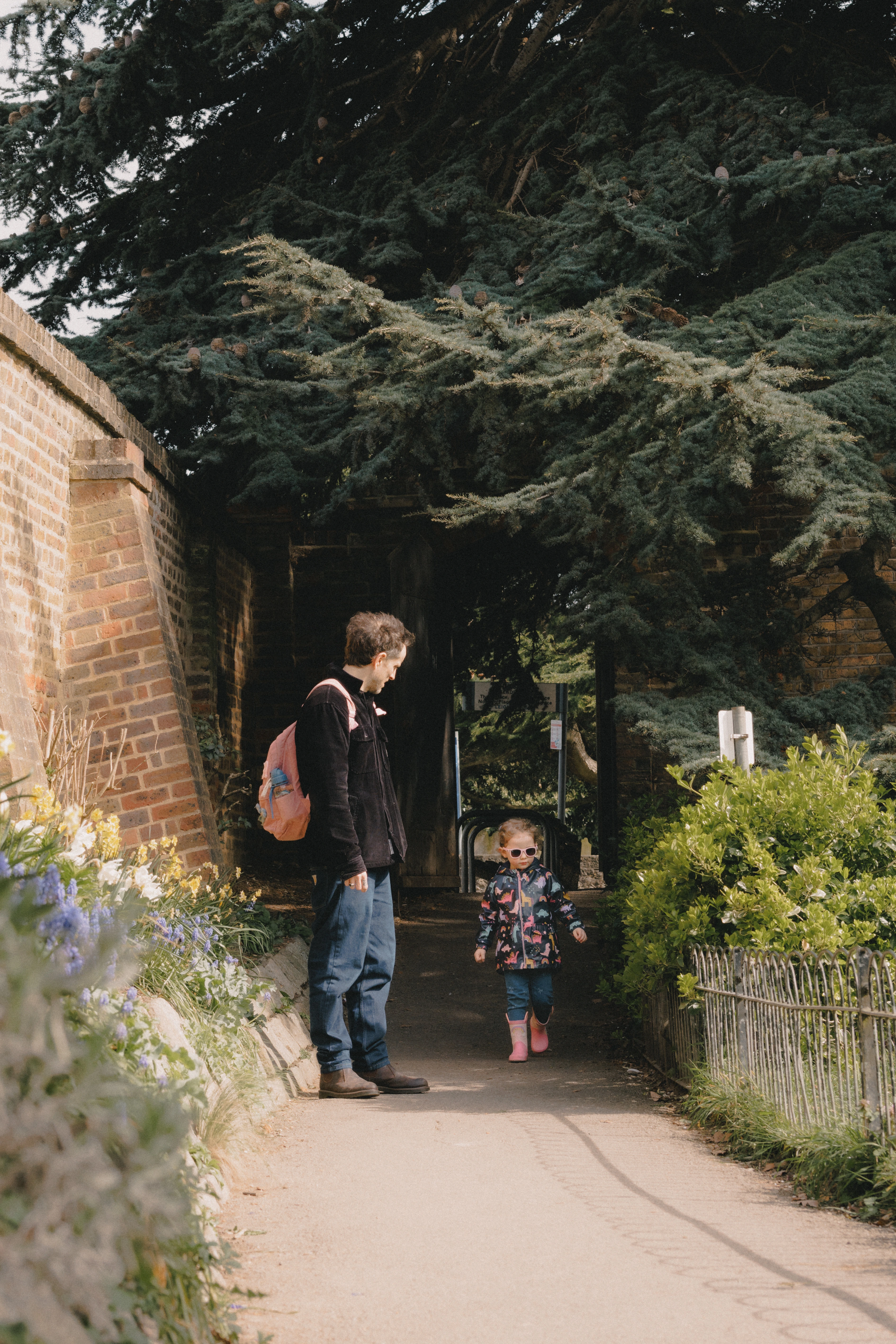 Father and daughter walking into Leigh-on-Sea park